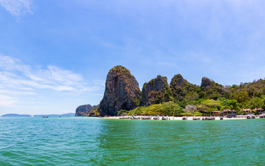 Naklejka premium Fisheye view of tropical limestone karst cliffs and emerald green sea at Phra Nang beach in Krabi, Thailand