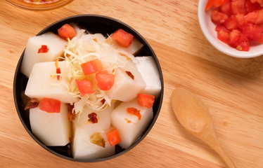 Tofu Jelly in bowl on wooden background,Diced tomatoes in a cup,Top view