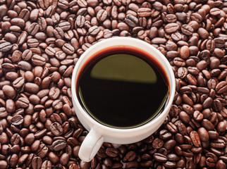 Close up roasted coffee bean,espresso in white cup