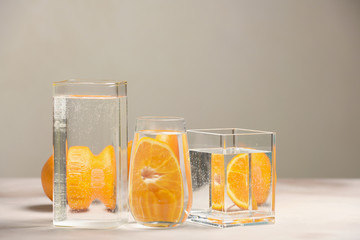Foods distorted through liquid and glass on light background.