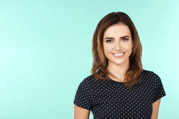 Fototapeta premium Smiling woman in casual clothes on color background