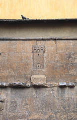 Florence, details of carved tower o na wall in the old city