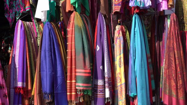 Assortment of colorful clothes for sale in local street market in Udaipur, Rajasthan, India. Close up