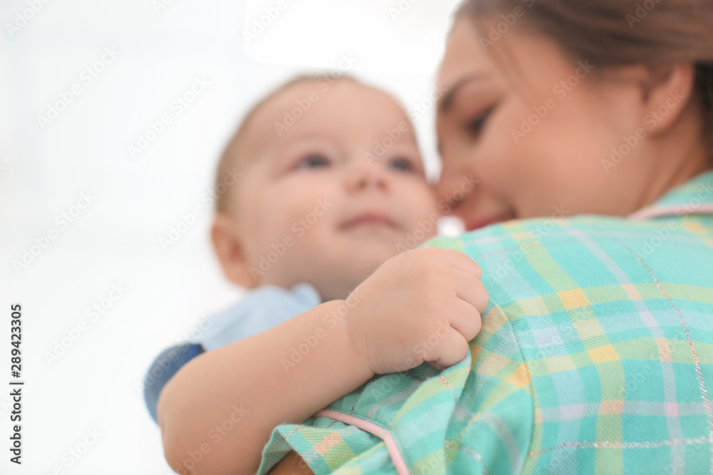 Canvas Prints loving mother with her baby on light background