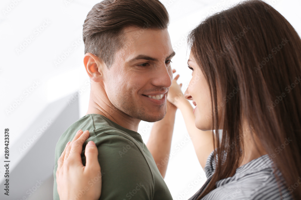 Wall mural beautiful young couple dancing indoors