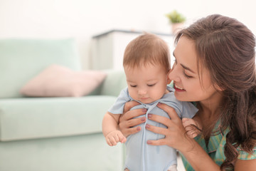 Loving mother with her baby at home