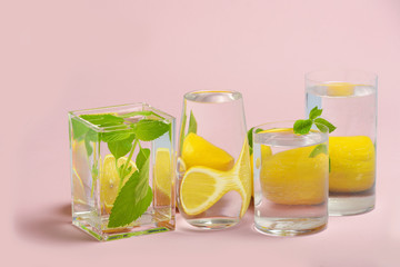 Foods distorted through liquid and glass on pink background.