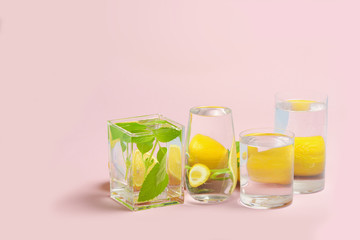 Foods distorted through liquid and glass on pink background.