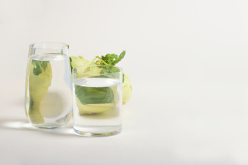 Foods distorted through liquid and glass on white background.