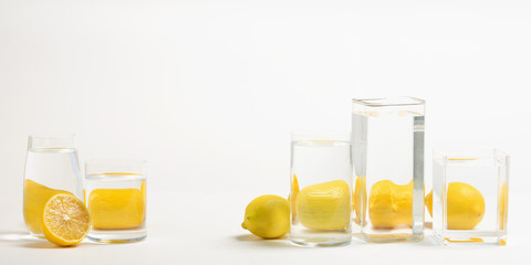 Foods distorted through liquid and glass on white background.