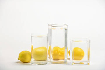 Foods distorted through liquid and glass on white background.