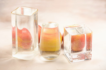 Foods distorted through liquid and glass on light background.