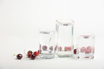 Foods distorted through liquid and glass on white background.