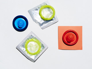 High angle colourful condoms on white background