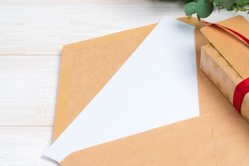 empty xmas wish list with little gift  on wooden background