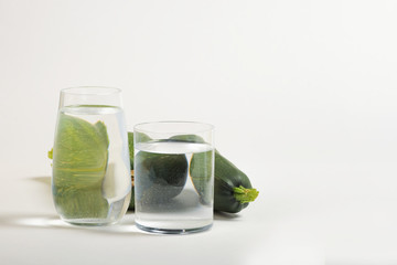 Foods distorted through liquid and glass on white background.