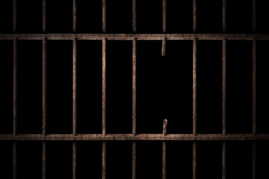 Prison cell with broken old prison bars on black background, way out to freedom