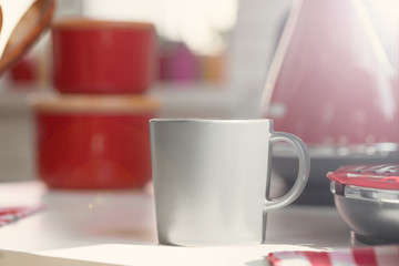 Cup of tea or coffee on modern kitchen background