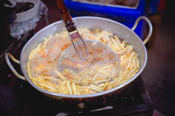 potato french fries deep fry in hot oil fatty street food sale in Thailand