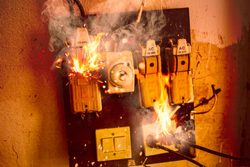 Short circuit fire burn danger of old electrical wire plug and broken circuit breaker