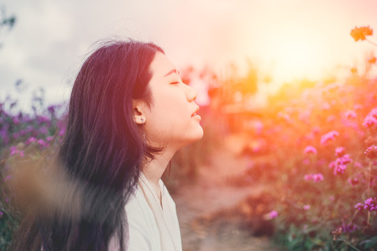 Beautiful Asian Girl Gentle Breathing In The Flower Field Sunset Beauty Moment Scene