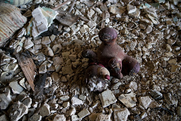 Burned interiors of industrial or residential building. Fire consequences concept. abandoned torn teddy bear