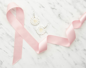 Top view ribbon and earrings on marble table
