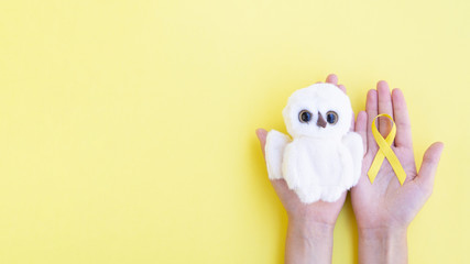 Top view ribbon and toy with yellow background
