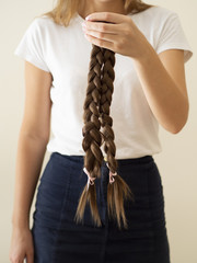 Close-up person holding up braids