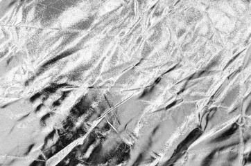 Crumpled silver material as abstract background