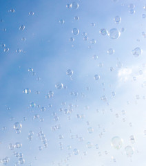 Soap bubbles fly in the blue sky