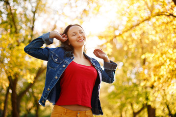 happy girl enjoying life and freedom in the autumn on the nature