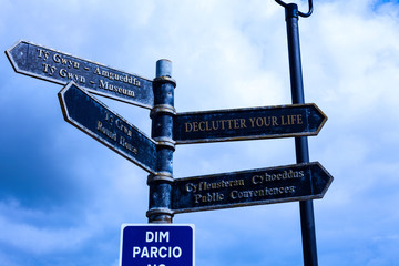 Fototapeta premium Writing note showing Declutter Your Life. Business concept for To eliminate extraneous things or information in life Road sign on the crossroads with blue cloudy sky in the background