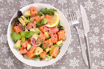 festive salad with salmon, avocado, onion and basil