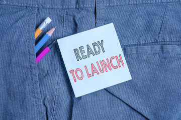 Handwriting text Ready To Launch. Conceptual photo an event to celebrate or introduce something new to market Writing equipment and blue note paper inside pocket of man work trousers