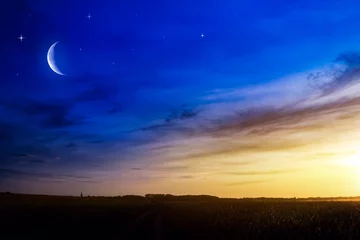 Zelfklevend Fotobehang Beautiful dark fluffy cloudy sky with sun rays . Crescent moon with beautiful sunset background . Generous Ramadan . New moon. Prayer time.  © yaalan
