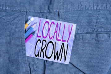 Conceptual hand writing showing Locally Grown. Concept meaning Produced Agricultural Countryside Fresh Vegetables Writing equipment and purple note paper inside pocket of trousers