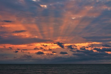 sunlight passing through the clouds in the morning on the beach