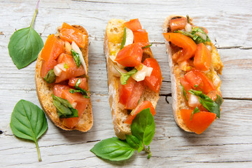 Bruscheta, antipasti Typical Italian with tomato, basil and toast