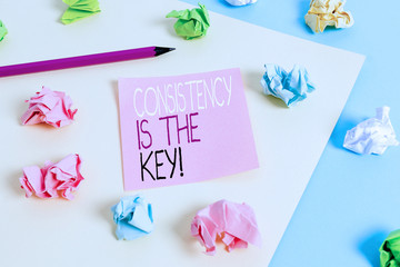 Writing note showing Consistency Is The Key. Business concept for by Breaking Bad Habits and Forming Good Ones Colored crumpled papers empty reminder blue yellow clothespin