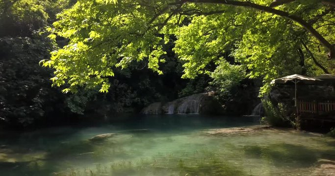 Kursunlu waterfall in Turkey, aerial footage under the trees, 4k