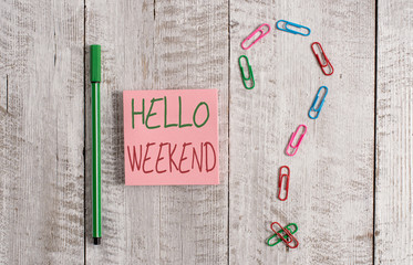 Word writing text Hello Weekend. Business photo showcasing Getaway Adventure Friday Positivity Relaxation Invitation Pastel colour note paper placed next to stationary above the wooden table