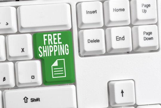 Conceptual hand writing showing Free Shipping. Concept meaning Freight Cargo Consignment Lading Payload Dispatch Cartage White pc keyboard with note paper above the white background
