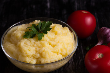 Mashed potato in glass bowl on the black background