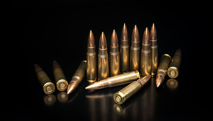 Bullet isolated on black background with reflexion. Rifle bullets close-up on black back....