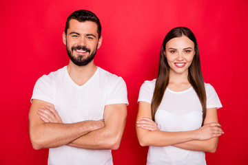 Photo of two charming casual beautiful cute handsome pretty sweet trendy nice people together coworking while wearing white t-shirts isolated over red background