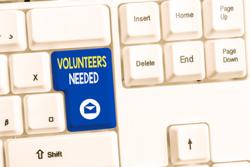 Word writing text Volunteers Needed. Business photo showcasing need work or help for organization without being paid White pc keyboard with empty note paper above white background key copy space
