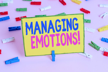 Word writing text Managing Emotions. Business photo showcasing ability be open to feelings and modulate them in oneself Colored clothespin papers empty reminder pink floor background office pin