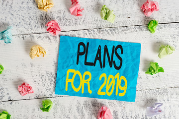 Word writing text Plans For 2019. Business photo showcasing an intention or decision about what one is going to do Crumpled colored rectangle square shaped paper reminder white wood desk