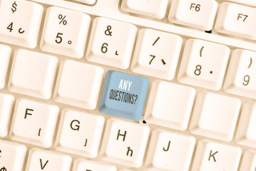 Writing note showing Any Questions Question. Business concept for you say write order to ask demonstrating about something White pc keyboard with note paper above the white background
